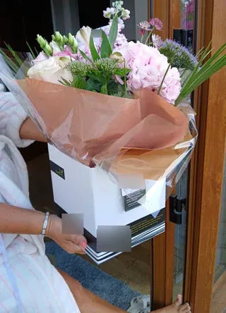 Pink roses and pale flowers in a Welch gift box