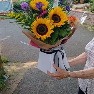 Sunflowers in Welch ribbon wrapping on delivery