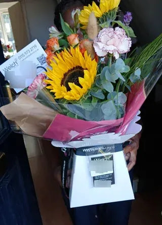 Sunflowers and pink hydrangea in a Welch carrier