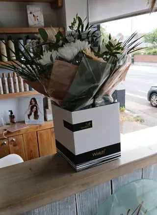White flowers delivered to a reception counter