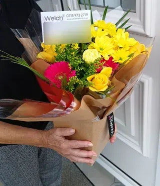 Bright yellow and pink flowers at a doorway