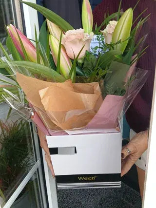 Pink roses and lily buds in a Welch gift box