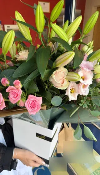 Pink roses and lilies in a large Welch gift box