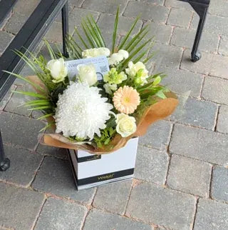 White and peach flowers delivered to a patio