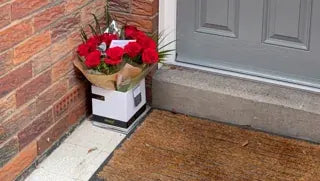Red roses delivered to a front porch