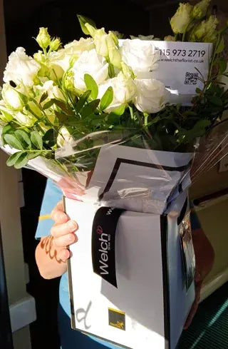White and cream flowers in a Welch carrier