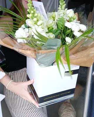 White flowers and lilies in a Welch gift box