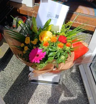 Bright pink gerbera and yellow rose bouquet