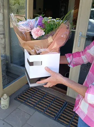 Pink and purple flowers in a Welch gift box