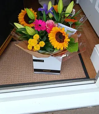 Sunflowers and pink flowers in a Welch gift box