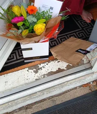 Yellow roses and mixed flowers at a doorstep