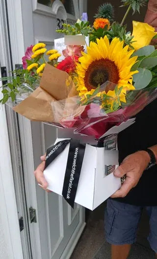 Sunflower and bright flowers in a Welch carrier
