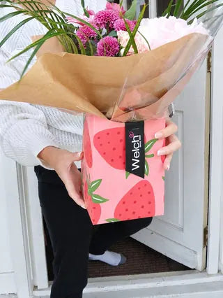 Pink flower bouquet in a strawberry-patterned Welch gift box