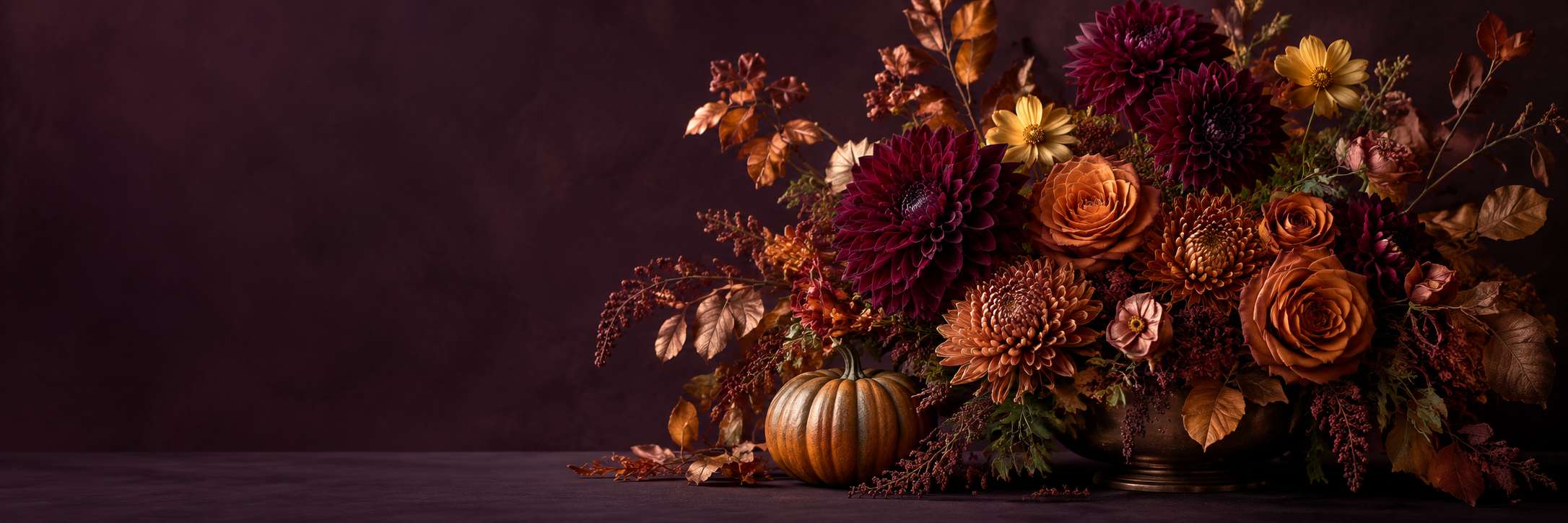Autumn flowers in burgundy and copper with a small pumpkin