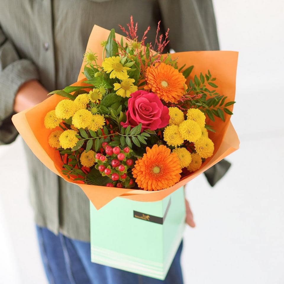 Bright autumn flower bouquet with roses, gerbera, and chrysanthemums in orange and yellow hues. The Autumn Glow, an Autumn Bouquet from Welch the Florist | Next Day Flower Delivery UK Florist
