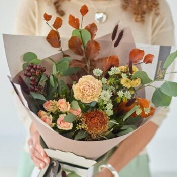Beautiful autumn bouquet with roses, greenery, and dried elements from Welch the Florist.
