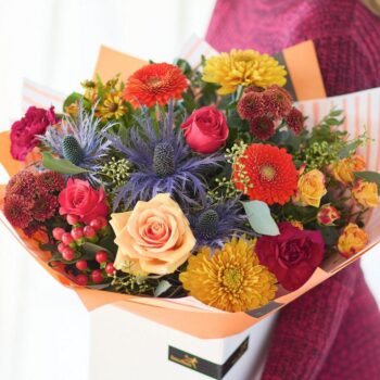 Colourful flower bouquet with roses, chrysanthemums, and thistles for floral arrangement. The Golden Hour, an Autumn Bouquet from Welch the Florist | Next Day Flower Delivery UK Florist.