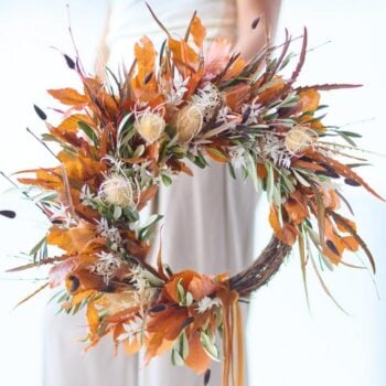 Beautiful autumn wreath with orange leaves and natural decorations. The Autumn Wreath from Welch the Florist | Next Day Flower Delivery UK Florist.